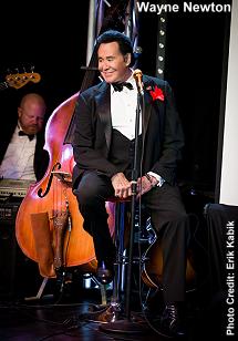 Wayne Newton sitting on stage